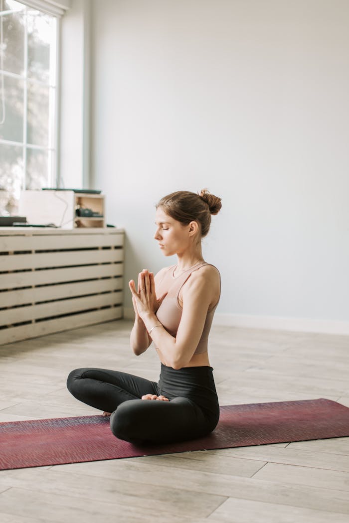 gallery-2 Adult woman practicing indoor meditation in a serene setting, focusing on mindfulness and wellness.